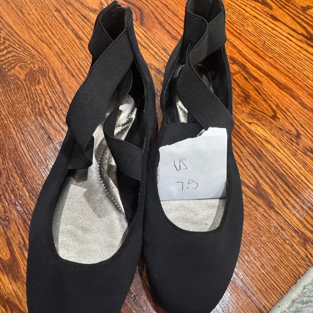 Black ballerina style flats with ankle straps and zippered back